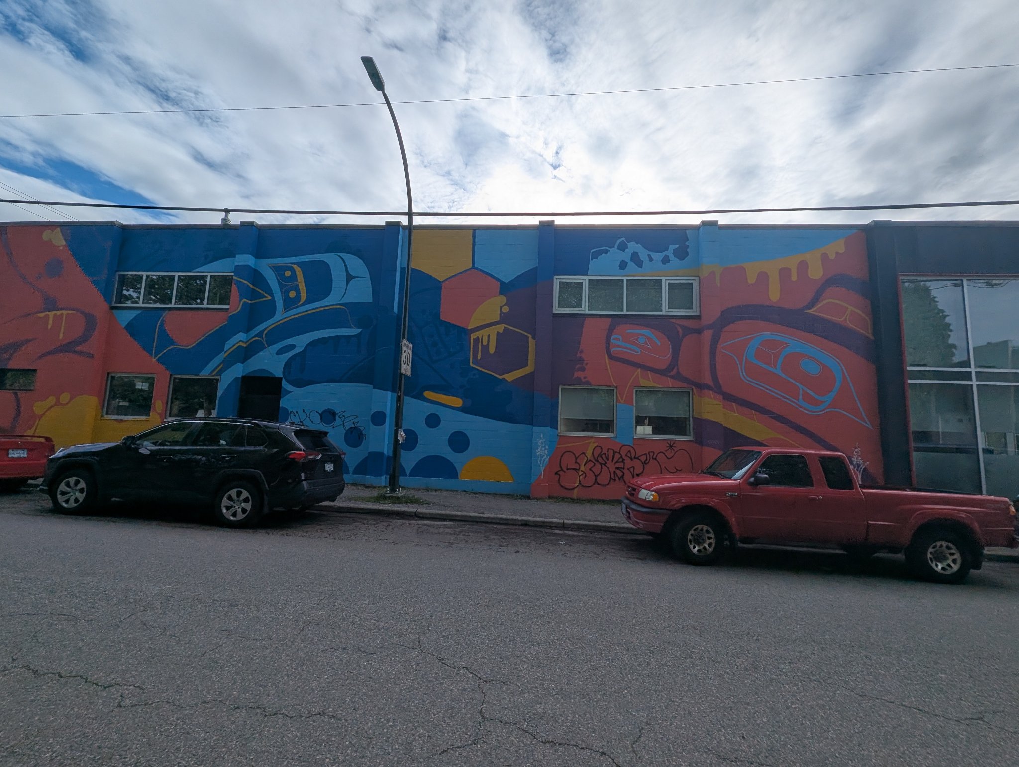 Red and blue mural in Vancouver, photographed May 27, 2026